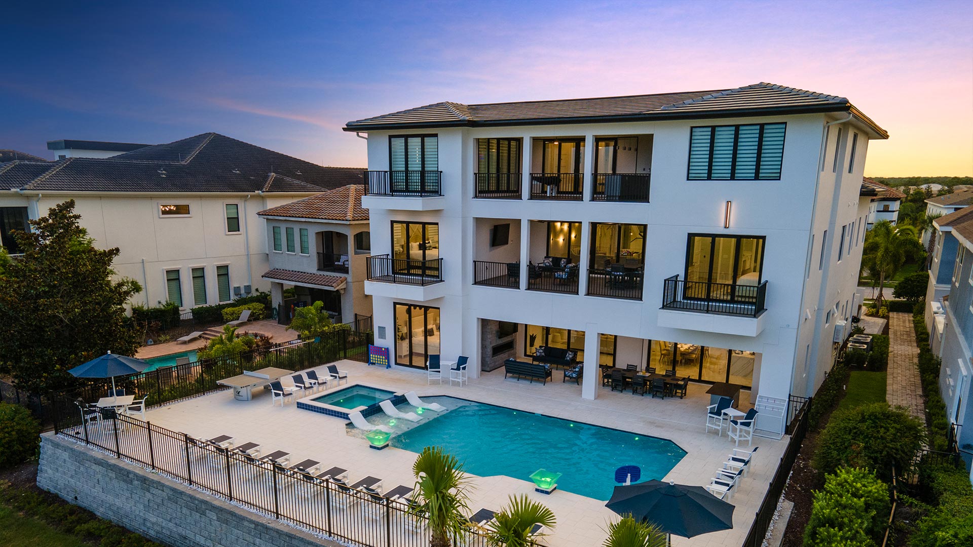 Backyard Of Memories Mansion With Balconies And Fenced Pool