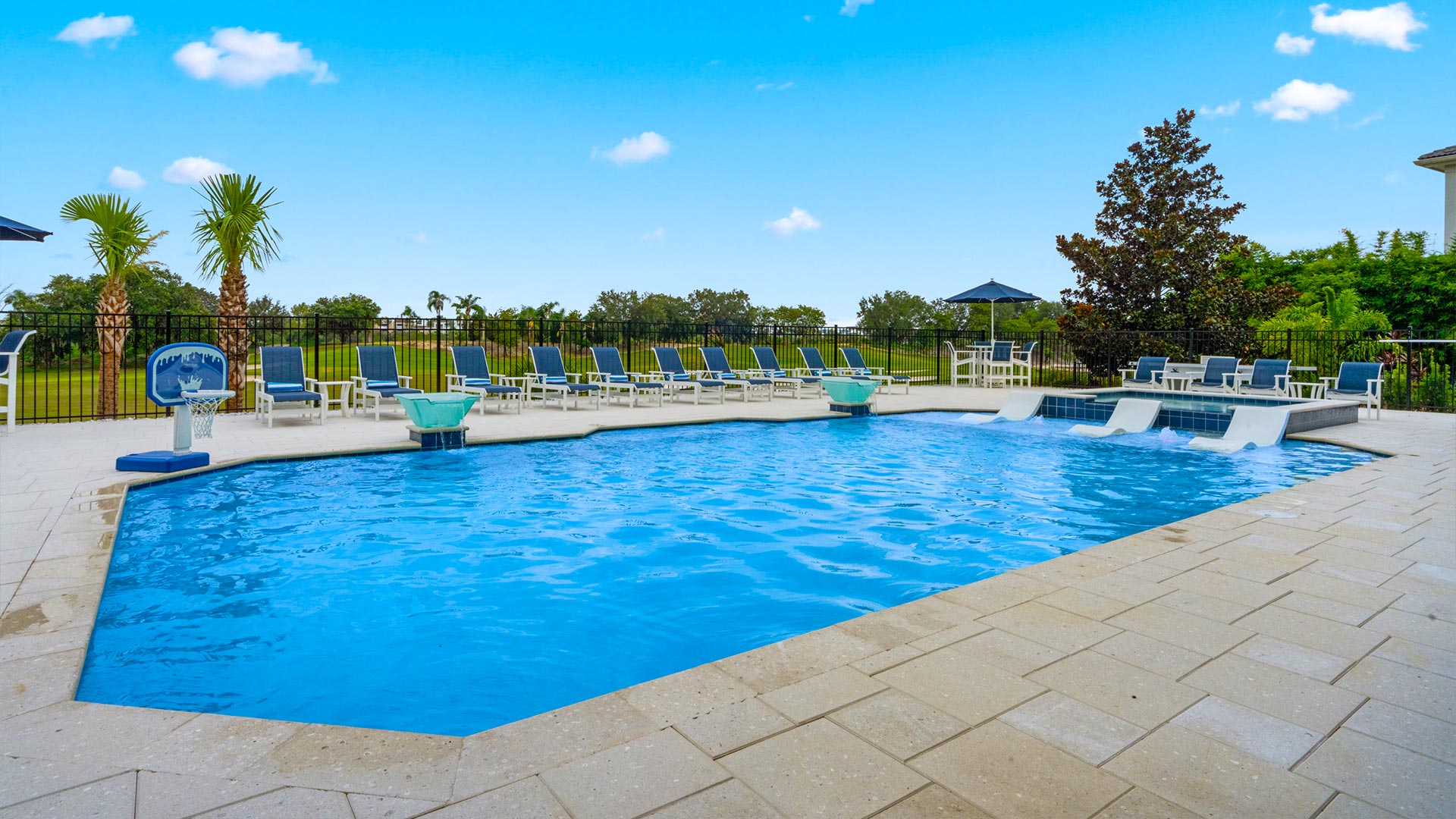 Backyard Pool With Cushioned Chaise Loungers And Views Of The Jack Nicklaus Golf Course